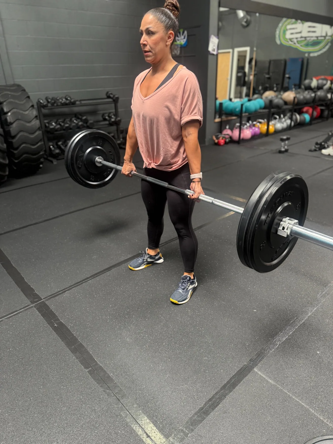 Client practicing a barbell deadlift