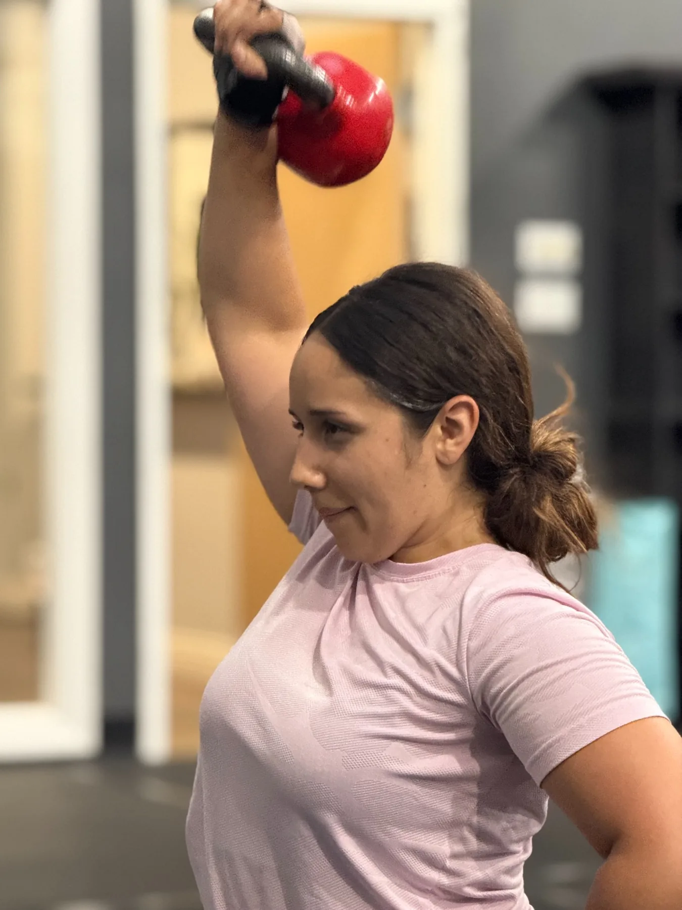 Woman lifting a kettlebell overhead