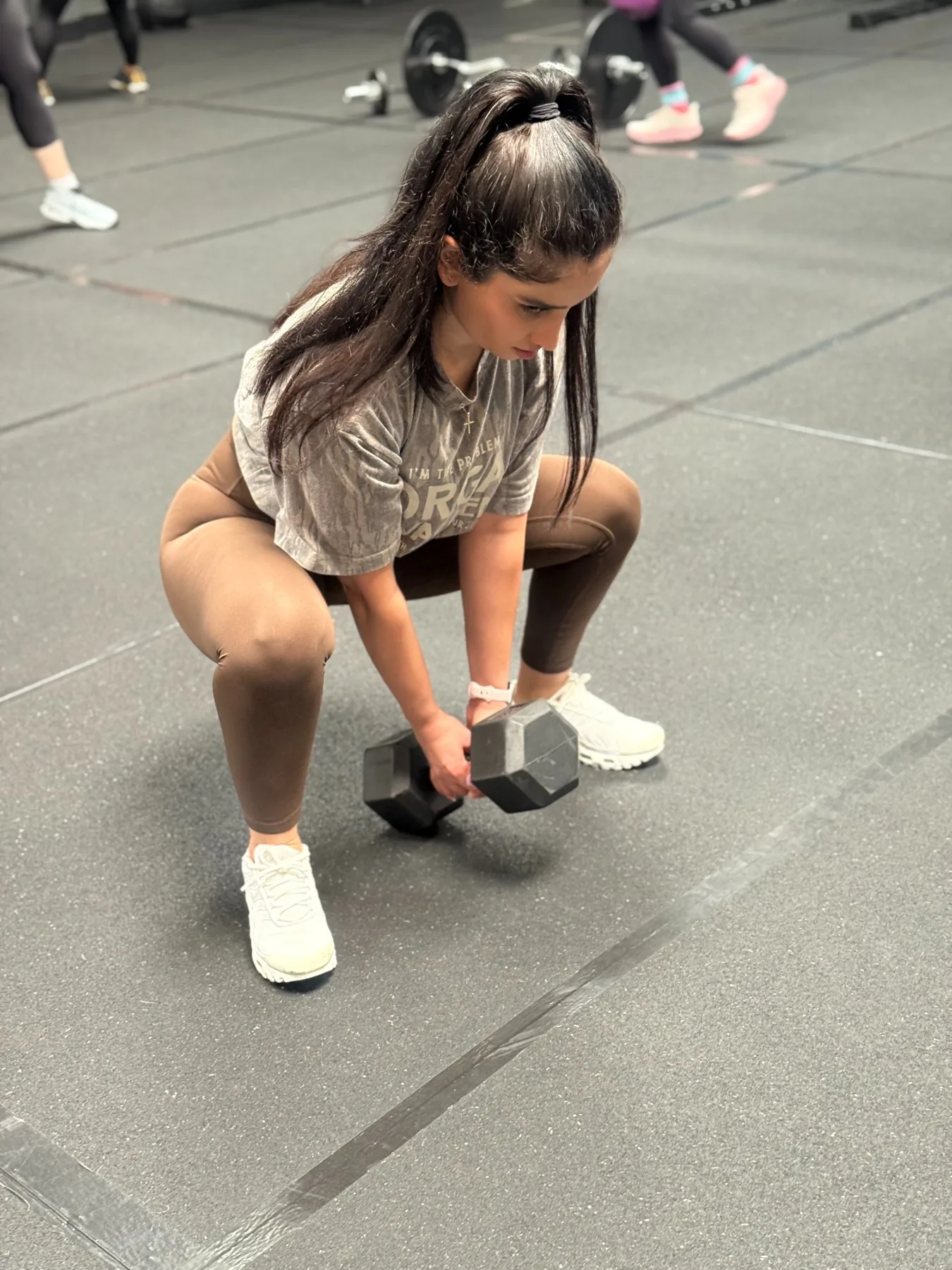 Woman training with a dumbbell in the gym