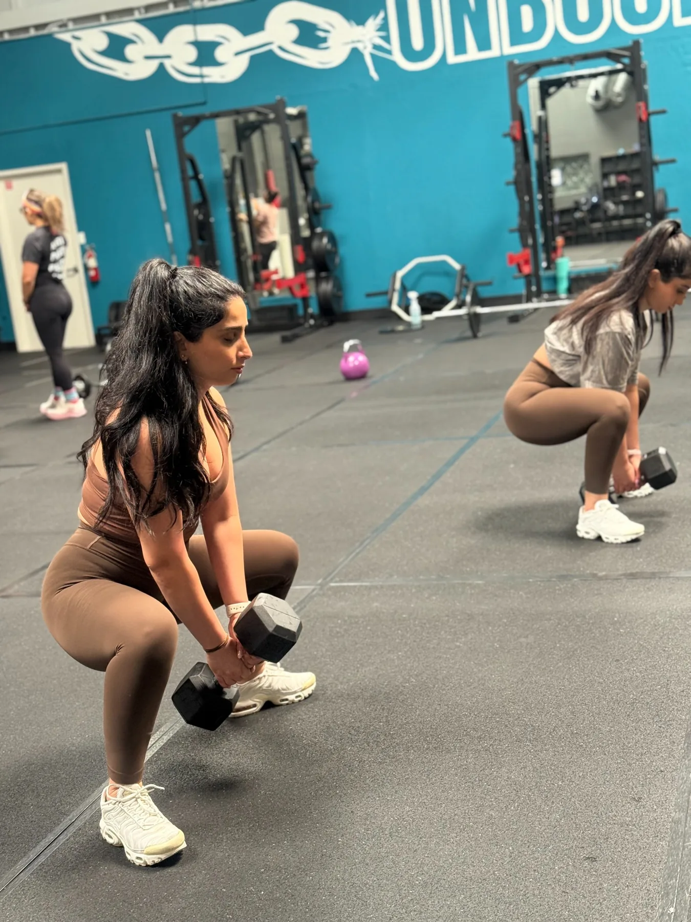 Women strength training together at the studio